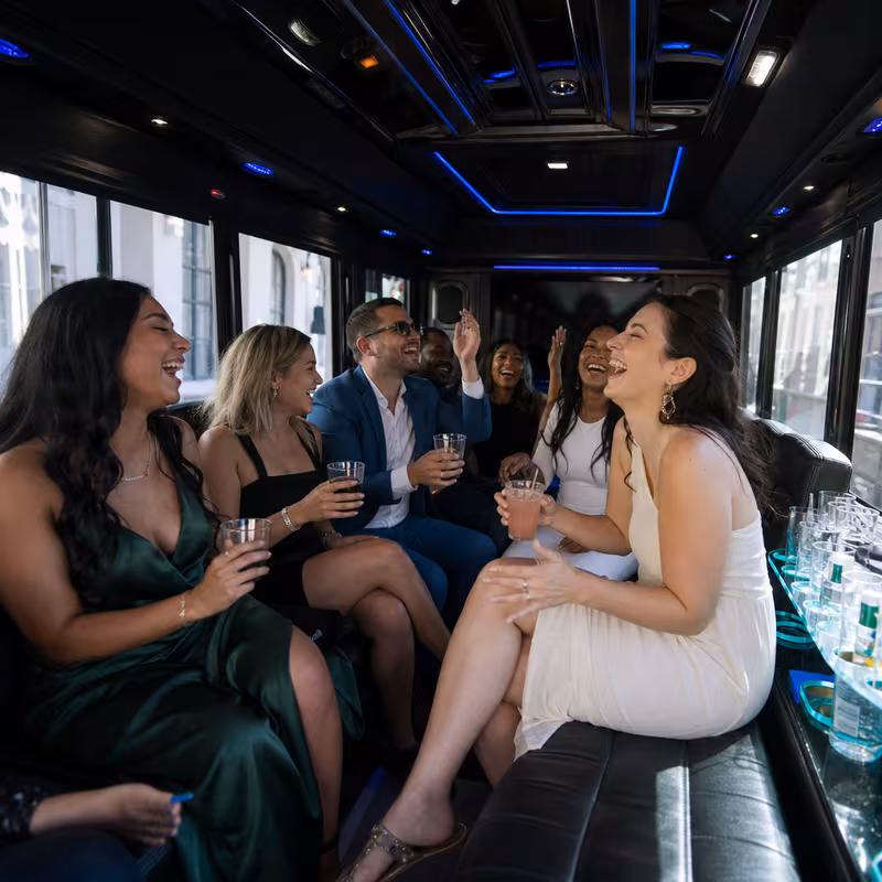 Party bus interior with wraparound leather seating and LED lighting in New Orleans