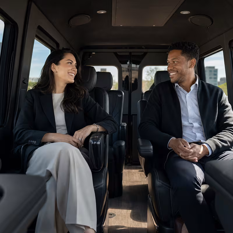 Group boarding a white charter bus for Corporate Transportation transportation in New Orleans