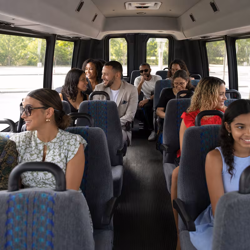 Group boarding a white charter bus for Private Event Transportation transportation in New Orleans