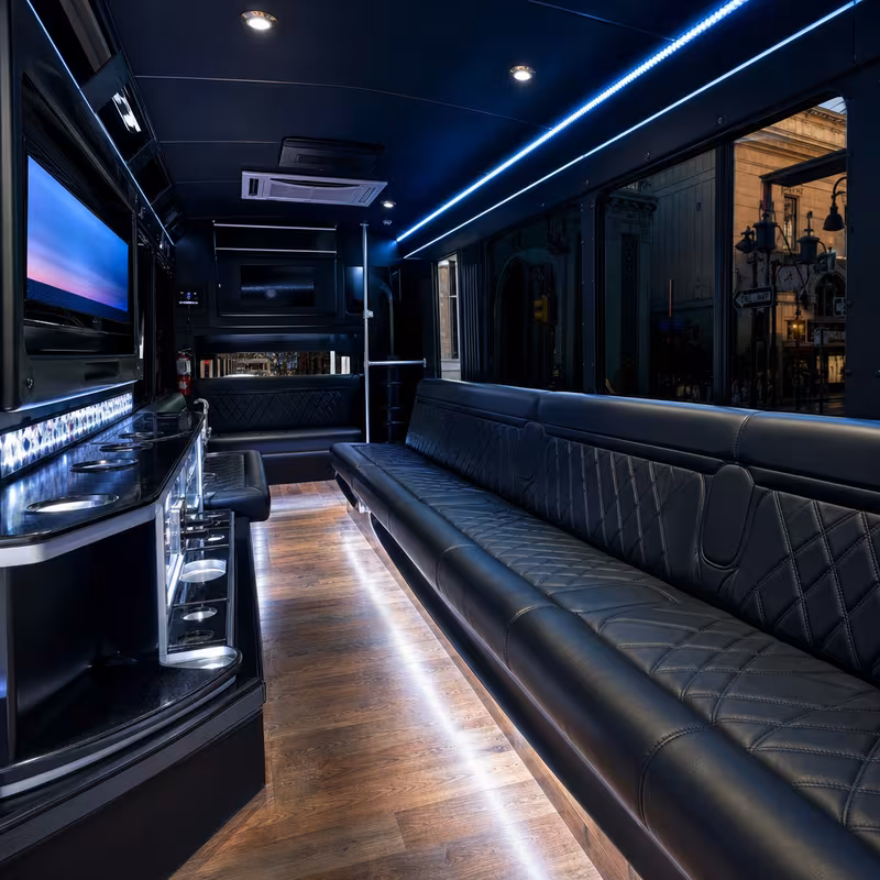 Party bus interior with wraparound leather seating and LED lighting in New Orleans