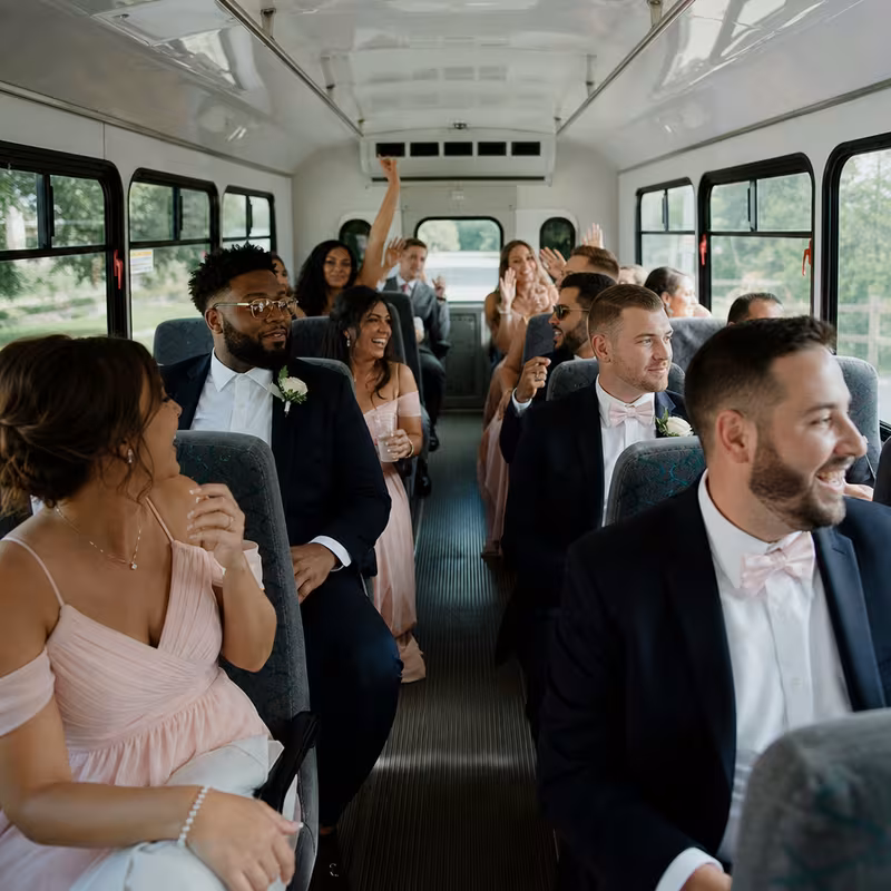 Group boarding a white charter bus for Wedding Transportation transportation in New Orleans