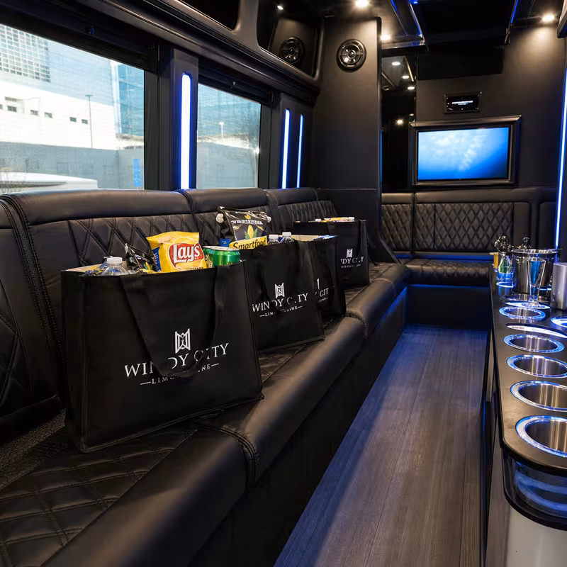 Party bus interior with wraparound leather seating and LED lighting in New Orleans